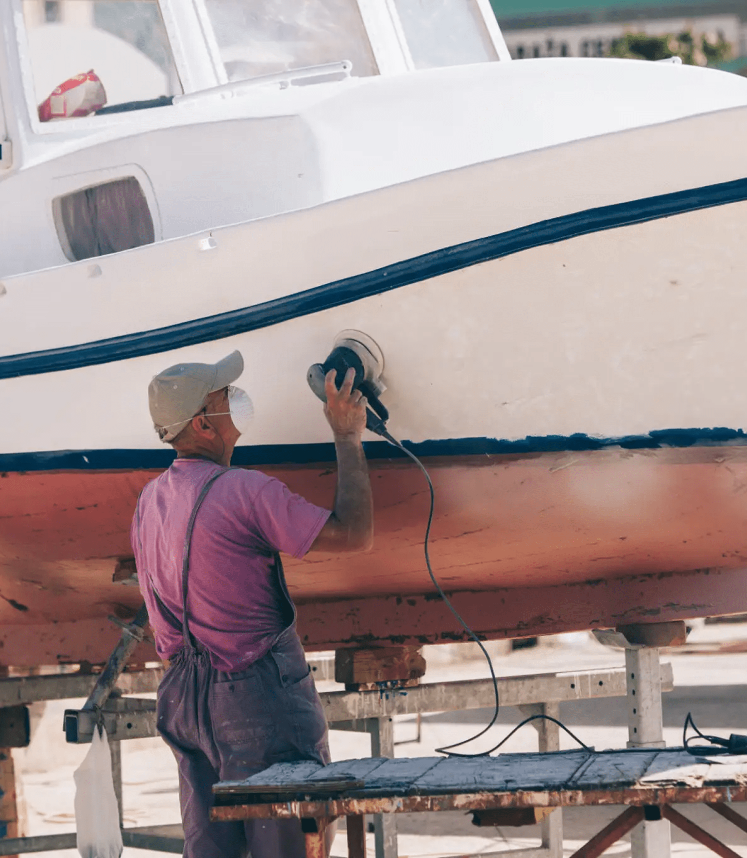 Man maintaining a boat's exterior