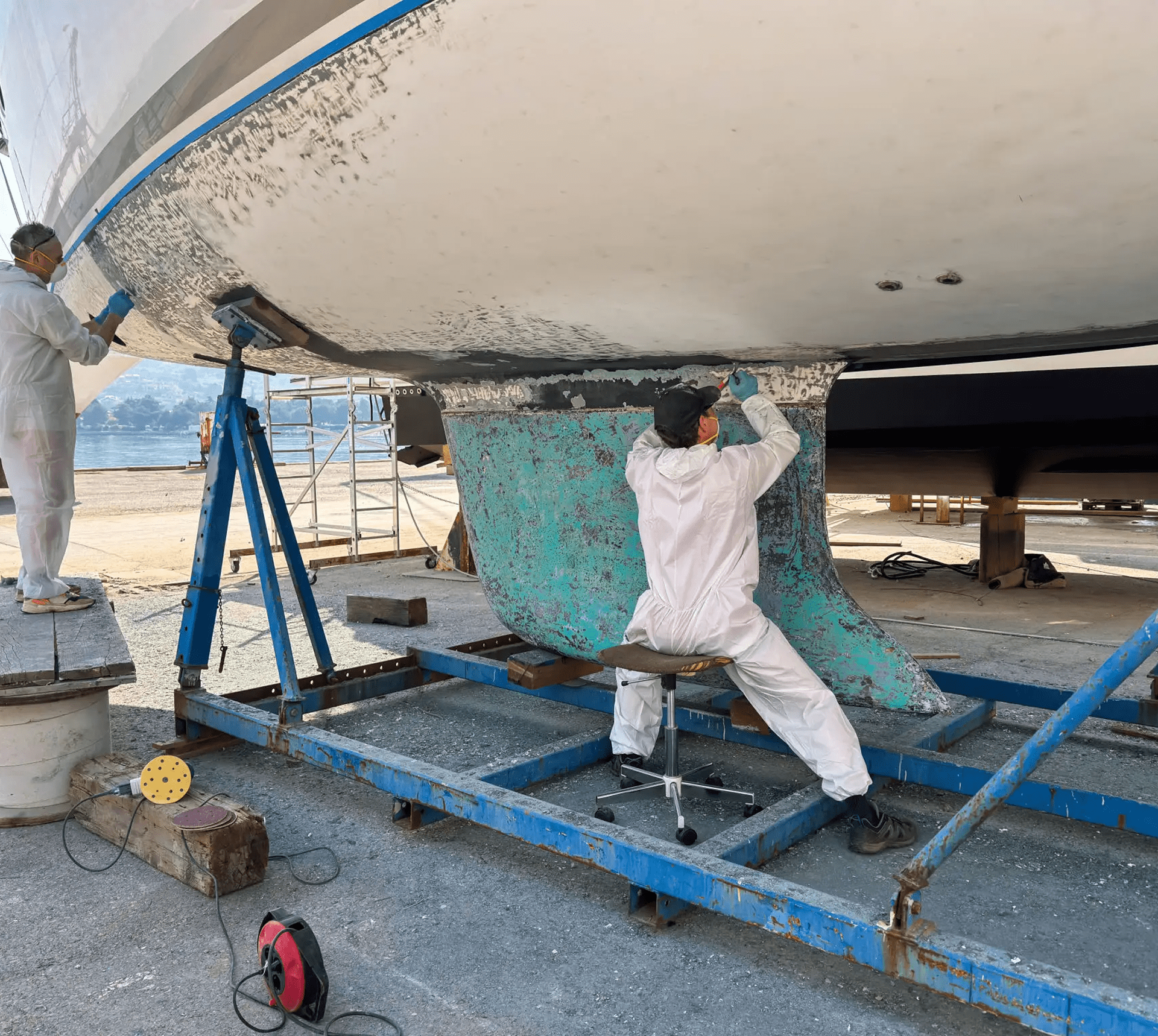 Boat maintenance with protective suits and tools